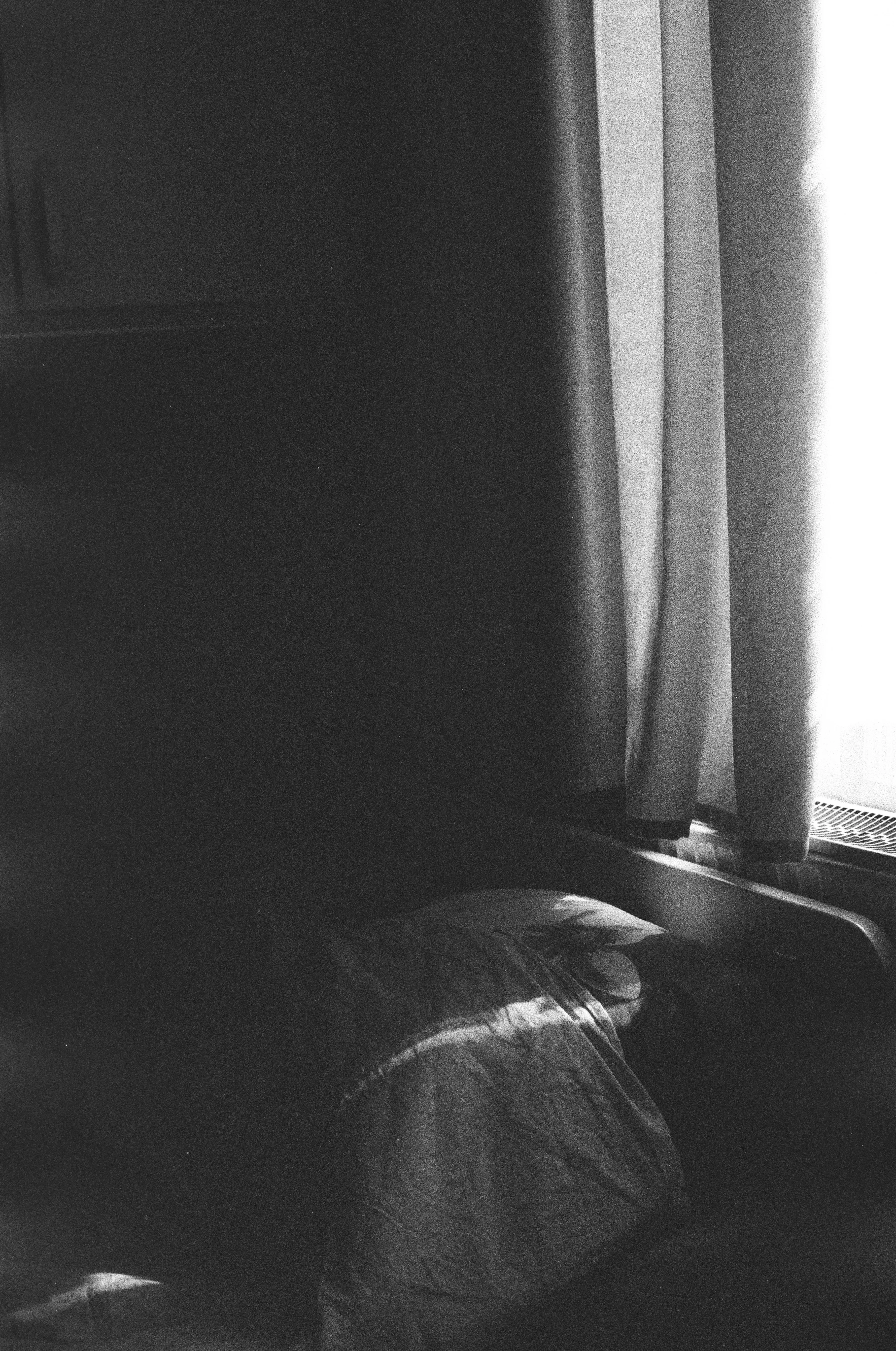 Dark interior with light through a curtained window